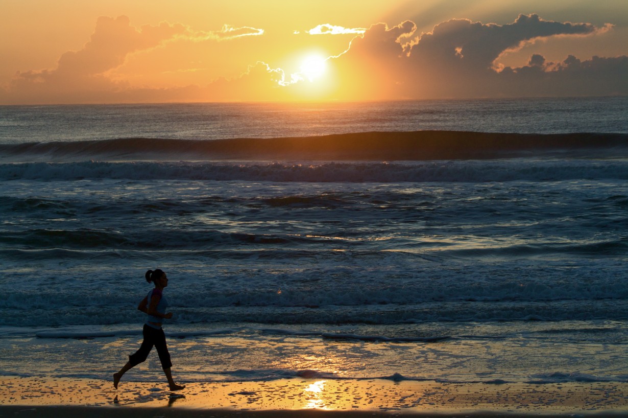 female runner dawn sunrise ocean