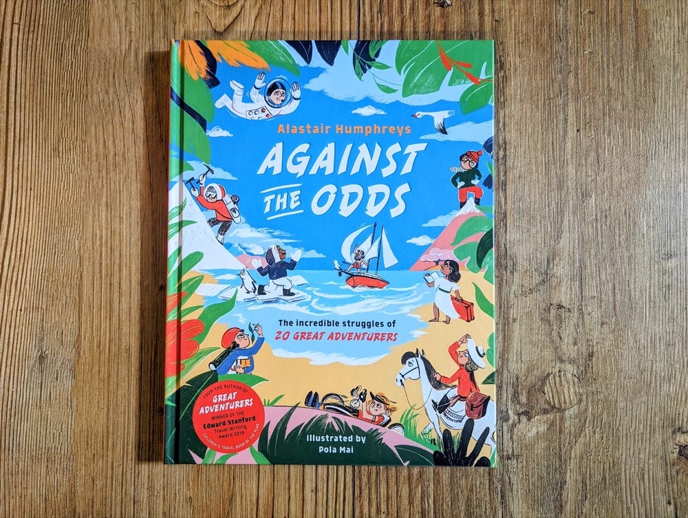 Books by Alastair Humphreys - Against the Odds: The Incredible Struggles of 20 Great Adventurers - Cover on Wooden Floor