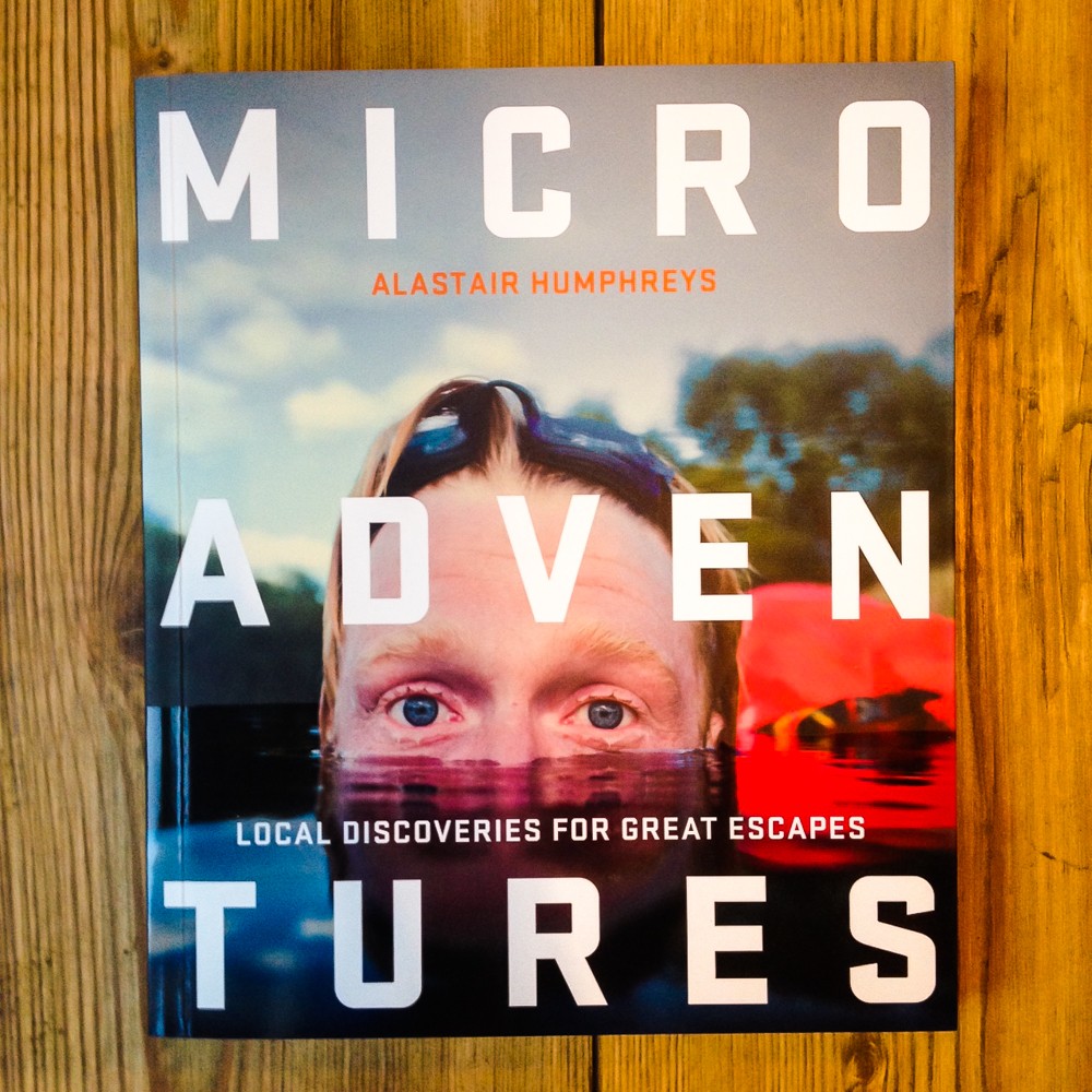 Books by Alastair Humphreys - Microadventures: Local Discoveries for Great Escapes - Cover on Wooden Floor