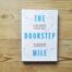 Books by Alastair Humphreys - The Doorstep Mile: Live More Adventurously Every Day - Cover on Wooden Floor
