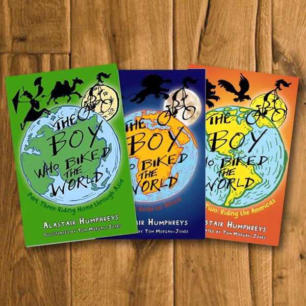 Books by Alastair Humphreys - The Boy who Biked the World Part One & Part Two Bundle - Cover on Wooden Floor