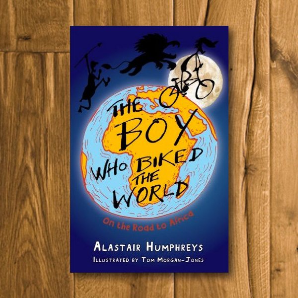 Books by Alastair Humphreys - The Boy Who Biked the World: Part One: On the Road to Africa - Cover on Wooden Floor