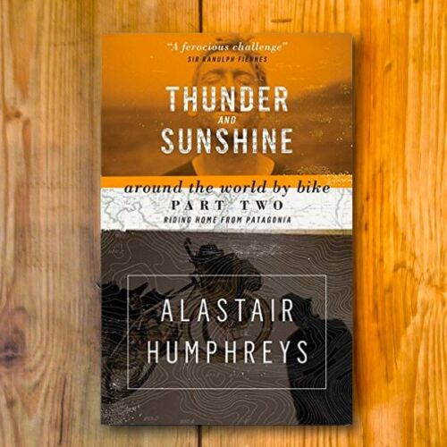 Books by Alastair Humphreys - Thunder and Sunshine: Around the World by Bike – Part 2 - Cover on Wooden Floor