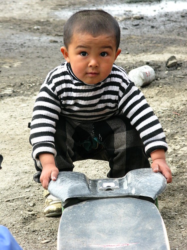 Kazakh kids play with Rig near Jinghe, Xinjiang, China