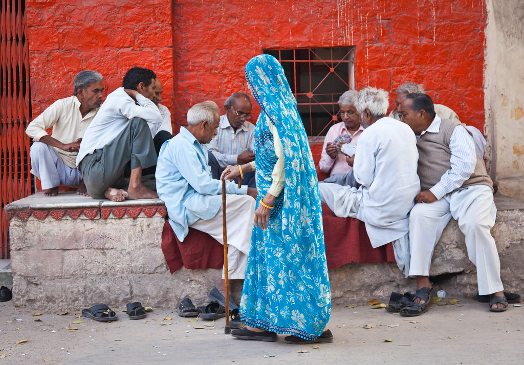 Woman walking past card game