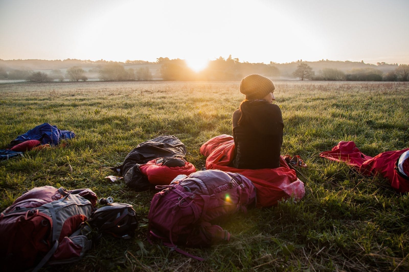 microadventure bivvy girl sunrise field